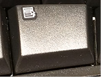 A photograph of the Application key on the keyboard. It looks like a mouse pointer over a context menu.